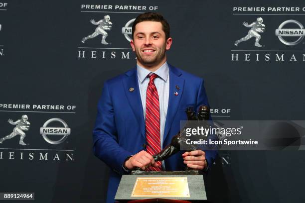 Heisman Trophy Winner University of Oklahoma quarterback Baker Mayfield poses with the Heisman Trophy during the Heisman Trophy Winner Press...