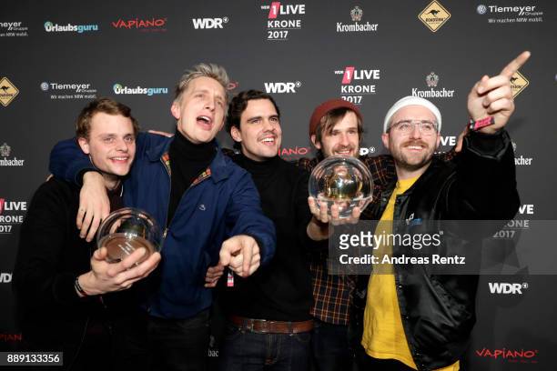 The band 'Kraftklub' celebrate their award during the 1Live Krone radio award at Jahrhunderthalle on December 07, 2017 in Bochum, Germany.