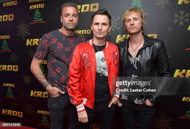 Chris Wolstenholme, Matt Bellamy, and Dominic Howard of Muse pose backstage during KROQ Almost Acoustic Christmas 2017 at The Forum on December 9,...