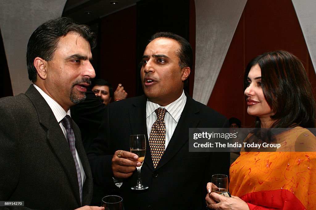 Travel trade buddies, Vikram Madhok of A&K (left) and Arjun Sharma of TUI-Le Passage to India, celebrate with Sharma's newly wed wife Jyotsna at the hotelier Sushil Gupta's Padma Shri party at Hyatt Regency in New Delhi.