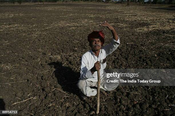 Soya Farmer Moolchand Patidar sitting at his agricultural land and looking for monsoon cloud in Bhopal, Madhya Pradesh, India