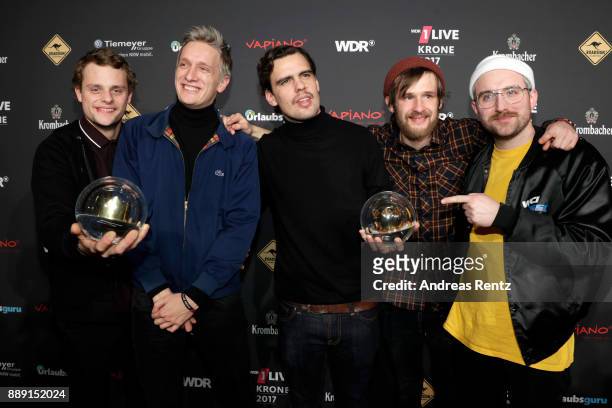 The band 'Kraftklub' celebrate their award during the 1Live Krone radio award at Jahrhunderthalle on December 07, 2017 in Bochum, Germany.