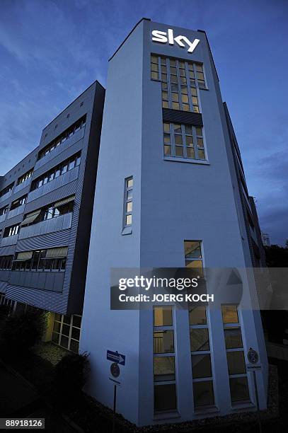 The logo of the pay-tv station "Sky" illuminates from the company's building in the southern German town of Unterfoehring, near Munich on July 8,...
