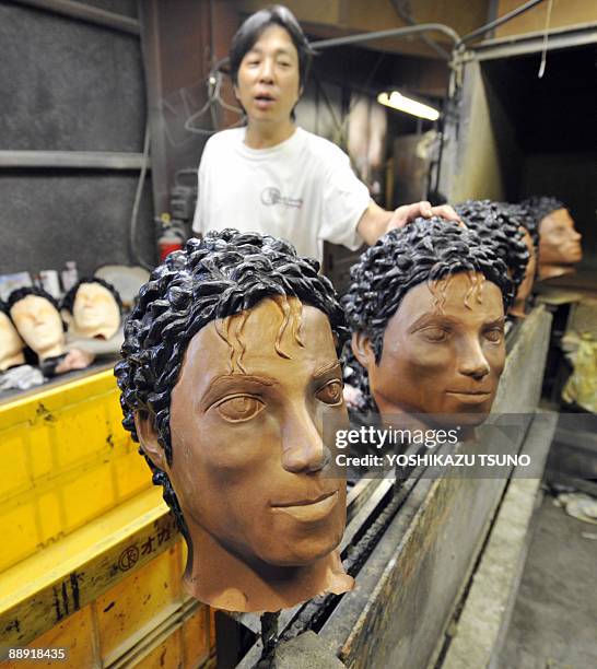 The masks resembled the late King of Pop Michael Jackson around the time when he released his "Thriller" album in the early 1980's are assembled at...