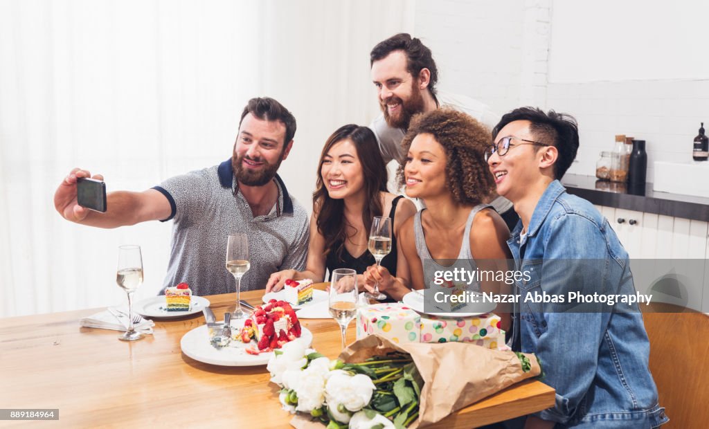 Taking selfie during a birthday celebration.