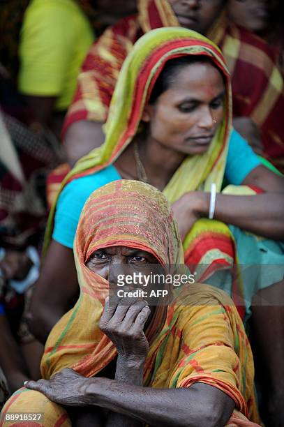 Bangladeshi villagers wait for relief supplies in Koyra, on the outskirts of the south-western city of Khulna on July 7, 2009. Bangladesh and India...