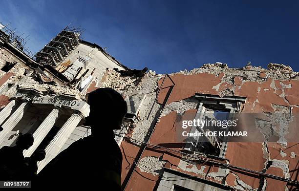 Firefighters wait for Italian Prime Minister Silvio Berlusconi and US President Barack Obama to view the damage done to central L'Aquila by an April...