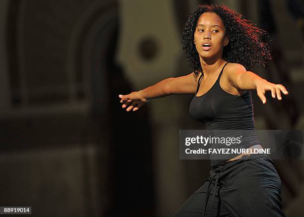 Dancer of an African band performs at a music and dance rally in front of the "Grande Poste" of Algiers City during the second Pan-African Cultural...