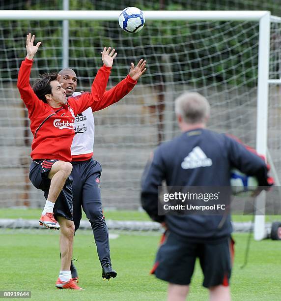 Yossi Benayoun and Ryan Babel both try and catch the ball as coach Sammy Lee looks on during a training session at Melwood Training Ground on July 9,...