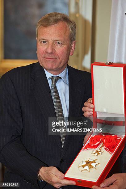 Secretary General Jaap de Hoop Scheffer poses with the Cross of Recognition after being granted by President of Latvia Valdis Zatlers on July 9 in...