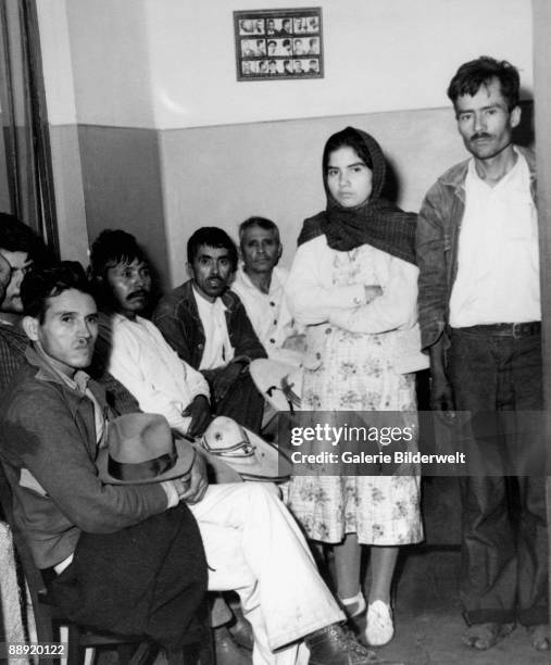 Relatives and friends of Mexican muralist David Alfaro Siqueiros gather in the police station after the artist made an attempt on the life of Russian...