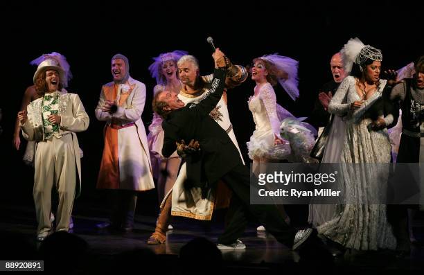 Writer Eric Idle and cast member John O'Huley perform in front of the cast during the curtain call for the opening night performance of "Monty...