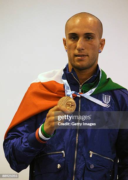 Bronze medalist Alessio Di Savino of Italy poses with her medal on the podium during the medal ceremony Men's Feather 57kg final on day 6 during the...