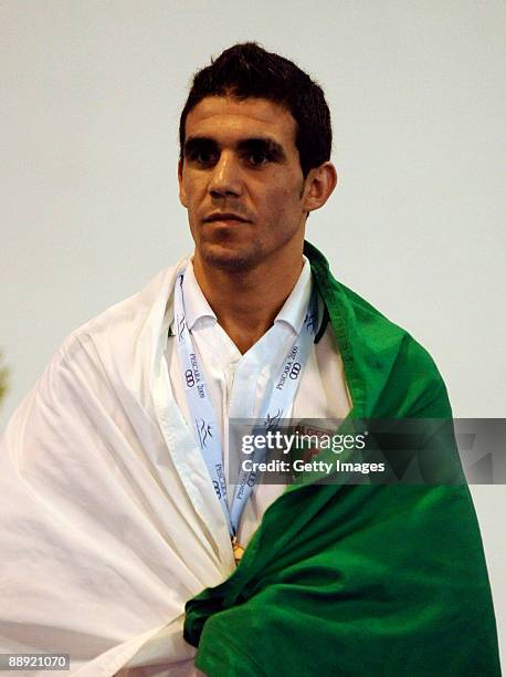 Bronze medalist Mohamed Amine Ouadahi of Algeri stands on the podium during the medal ceremony Men's Feather 57kg final on day 6 during the XVI...