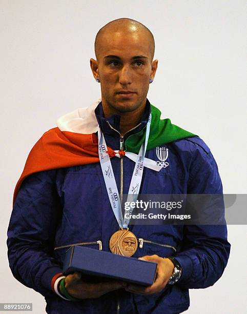 Bronze medalist Alessio Di Savino of Italy stands on the podium during the medal ceremony Men's Feather 57kg final on day 6 during the XVI...