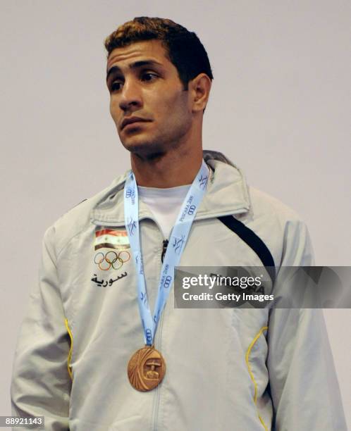 Bronze medalist Salamana Wessan of Syrian Arab Republic stands on the podium during the medal ceremony Men's Bantam 54kg final on day 6 during the...