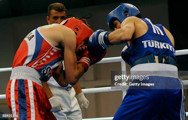 Branimir Stankovic of Serbia fights Kerem Gurgen of Turkey during the Men's Feather 57kg on day 6 during the XVI Mediterranean Games at the Sports...