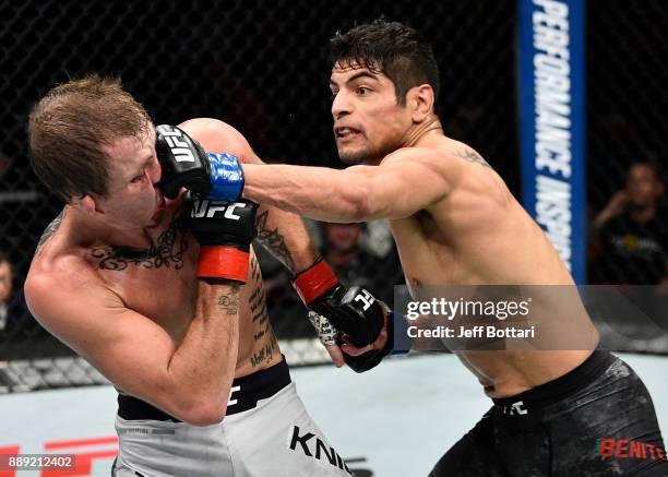 Gabriel Benitez of Mexico punches Jason Knight in their featherweight bout during the UFC Fight Night event inside Save Mart Center on December 9,...