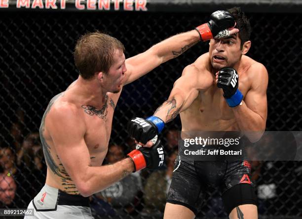 Gabriel Benitez of Mexico punches Jason Knight in their featherweight bout during the UFC Fight Night event inside Save Mart Center on December 9,...