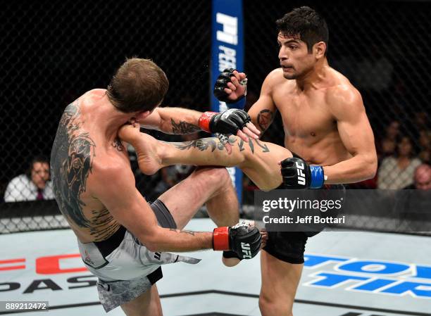 Gabriel Benitez of Mexico kicks Jason Knight in their featherweight bout during the UFC Fight Night event inside Save Mart Center on December 9, 2017...