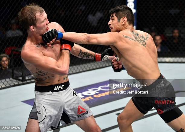 Gabriel Benitez of Mexico punches Jason Knight in their featherweight bout during the UFC Fight Night event inside Save Mart Center on December 9,...