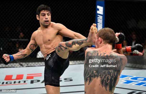 Gabriel Benitez of Mexico kicks Jason Knight in their featherweight bout during the UFC Fight Night event inside Save Mart Center on December 9, 2017...