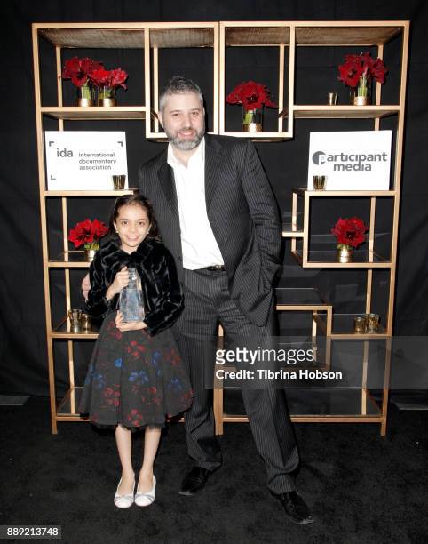 Bana al-Abed and Evgeny Afineevsky pose with the Courage Under Fiere Award at the 33rd Annual IDA Documentary Awards at Paramount Theatre on December...