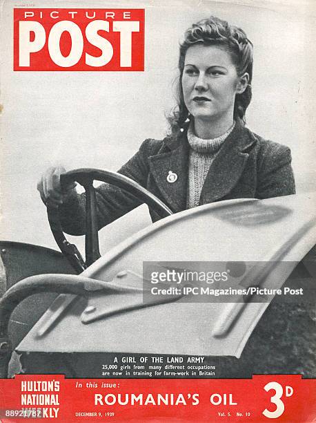 The cover of Picture Post magazine featuring a British member of the Women's Land Army working on a farm in the early months of World War II,...