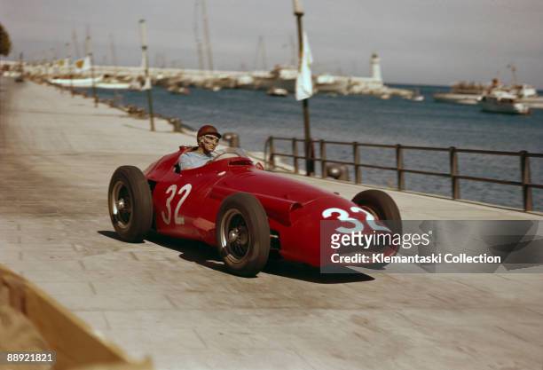 The Monaco Grand Prix; Monte Carlo, May 19, 1957. Juan Manuel Fangio in his Maserati 250F on the approach to Tabac Corner on the harbor front.