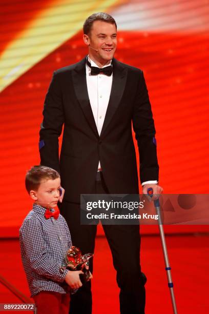 Winner of the Golden Heart Manuel Neuer and child Fredrik during the Ein Herz Fuer Kinder Gala show at Studio Berlin Adlershof on December 9, 2017 in...