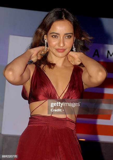 Indian Bollywood actress Neha Sharma poses for a picture at the screening of 'The grand tour season 2' in Mumbai late on December 9, 2017. / AFP...