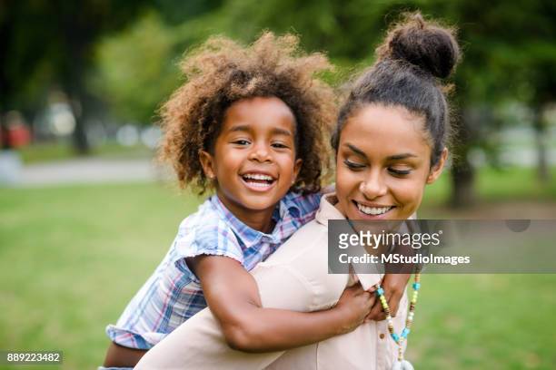 mother and daughter - piggyback stock pictures, royalty-free photos & images