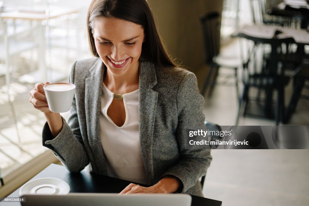 Business woman having coffee and checking mailbox