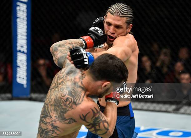 Cub Swanson punches Brian Ortega in their featherweight bout during the UFC Fight Night event inside Save Mart Center on December 9, 2017 in Fresno,...