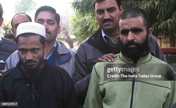 Suspected Harkatul-Jihad-e-Islami Militants Lukhtur Rehman from Bangla Desh and Mohd Ameen Wani from Kashmir showing in front of photographer's after...