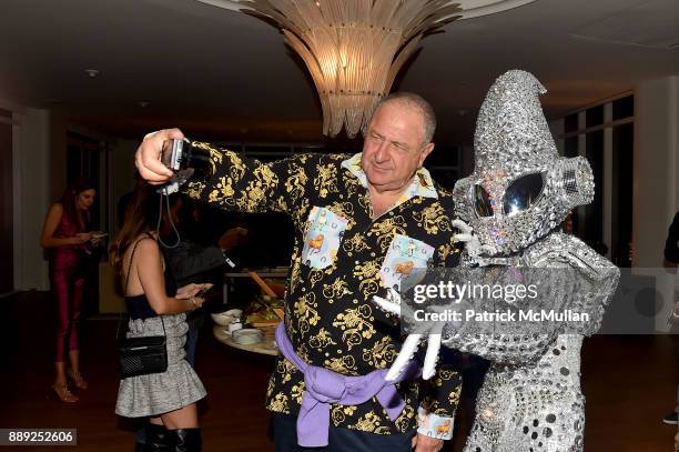 Jean Pigozzi poses with performers during the Galerie Gmurzynska Dinner in Honor of Jean Pigozzi at the Penthouse at the Faena Hotel Miami Beach on...