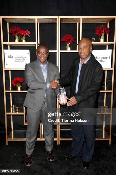 Yance Ford and Charles Burnett pose with the Emerging Documentary Filmmaker Award at the 33rd Annual IDA Documentary Awards at Paramount Theatre on...