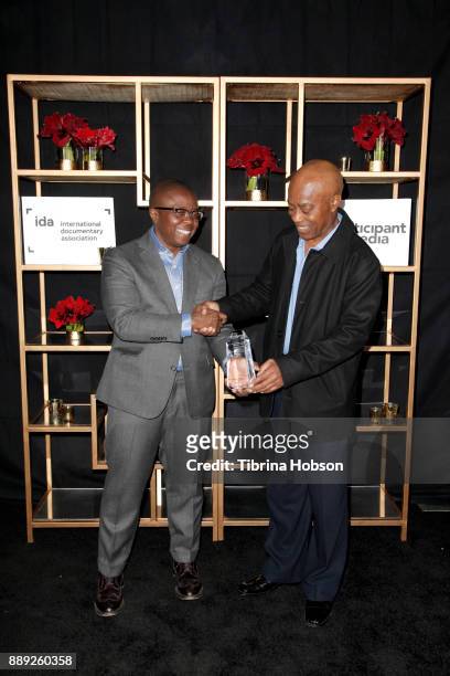 Yance Ford and Charles Burnett pose with the Emerging Documentary Filmmaker Award at the 33rd Annual IDA Documentary Awards at Paramount Theatre on...