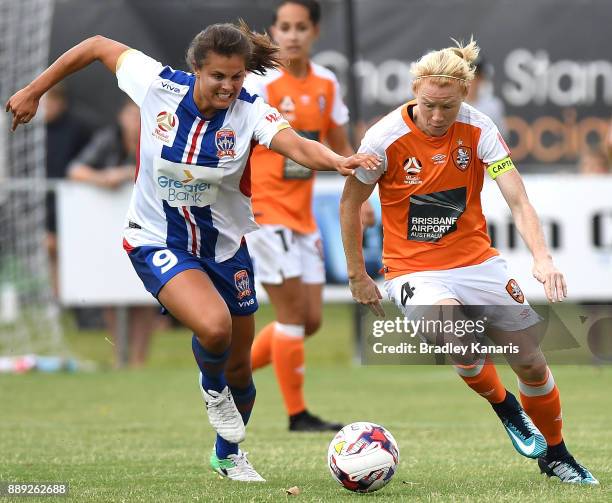 Clare Polkinghorne of the Roar and Katherine Stengel of the Jets compete for the ball during the round seven W-League match between the Brisbane Roar...