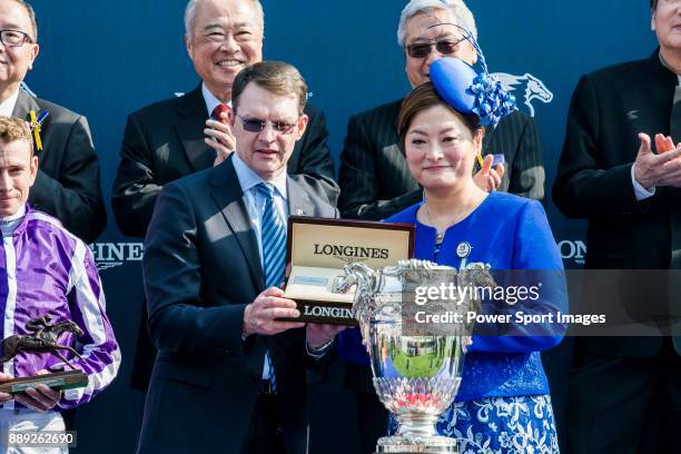 Trainer Aidan Patrick O'Brien of Highland Reel receives the prize from Karen Au-Yeung, vice President of LONGINES Hong Kong, after wining the...