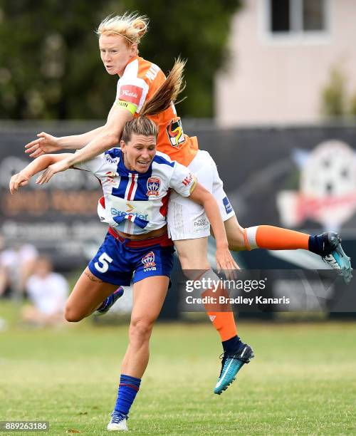 Clare Polkinghorne of the Roar and Arin Gilliland of the Jets challenge for the ball during the round seven W-League match between the Brisbane Roar...