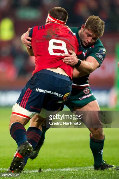 Stander of Munster tackled by Tom Youngs of Leicester during the European Rugby Champions Cup Round 3 match between Munster Rugby and Leicester...