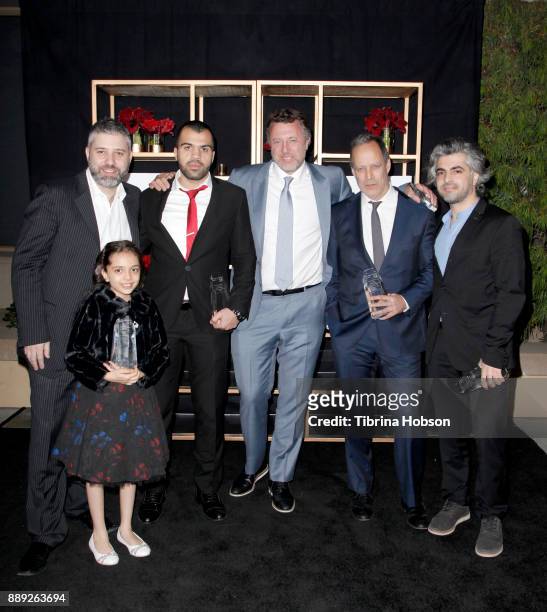 Evgeny Afineevsky, Bana al-Abed, Hamoud Al-Mousa, Nick Quested, Sebastian Junger, and Firas Fayyad pose with the Courage Under Fire award at the 33rd...