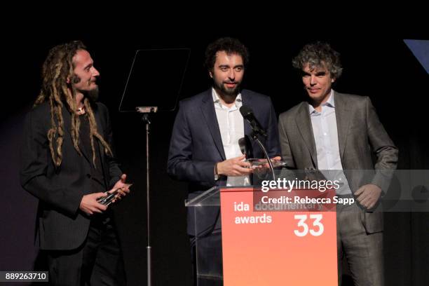 Manuel Pereira, Chico Pereira, and Gabriel Molera accept the Best Writing Award at the 33rd Annual IDA Documentary Awards at Paramount Theatre on...