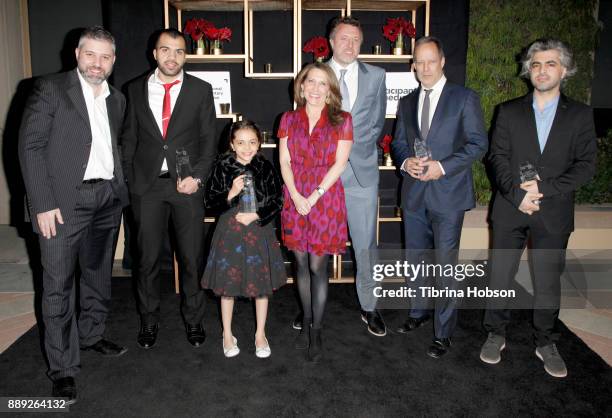 Evgeny Afineevsky, Hamoud Al-Mousa, Bana al-Abed, Jessica Yellin, Nick Quested, Sebastian Junger, and Firas Fayyad pose with the Courage Under Fire...