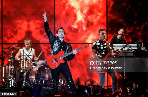 Dominic Howard, Matt Bellamy, and Chris Wolstenholme of Muse perform onstage during KROQ Almost Acoustic Christmas 2017 at The Forum on December 9,...