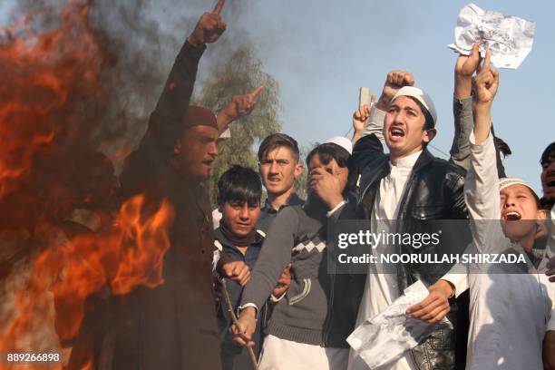 Afghan protesters burn an effigy of US President Donald Trump during a protest in Jalalabad on December 10 following US President Donald Trump's...