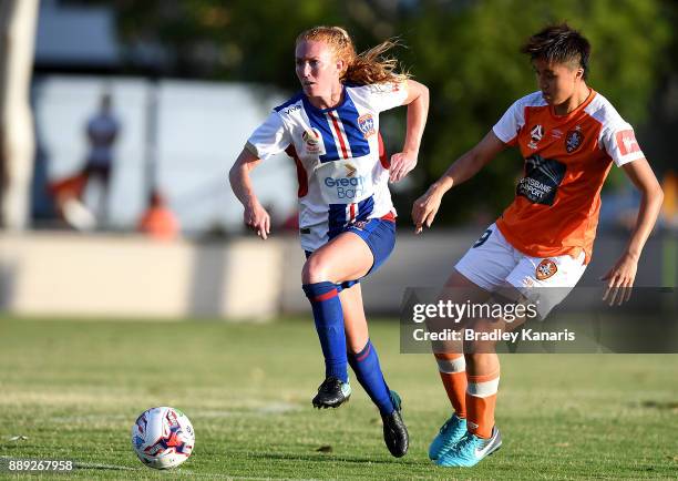 Victoria Huster of the Jets breaks away from the defence of Wai Ki Cheung of the Roar during the round seven W-League match between the Brisbane Roar...