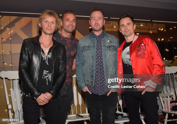 Ted Stryker poses backstage with Dominic Howard, Chris Wolstenholme and Matt Bellamy of Muse performs onstage during KROQ Almost Acoustic Christmas...