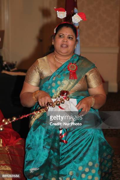Tamil woman singing Christmas songs while using jingle bells during the V Rambaikulam Girls Maha Vidyalayam Old Students Association Christmas gala...